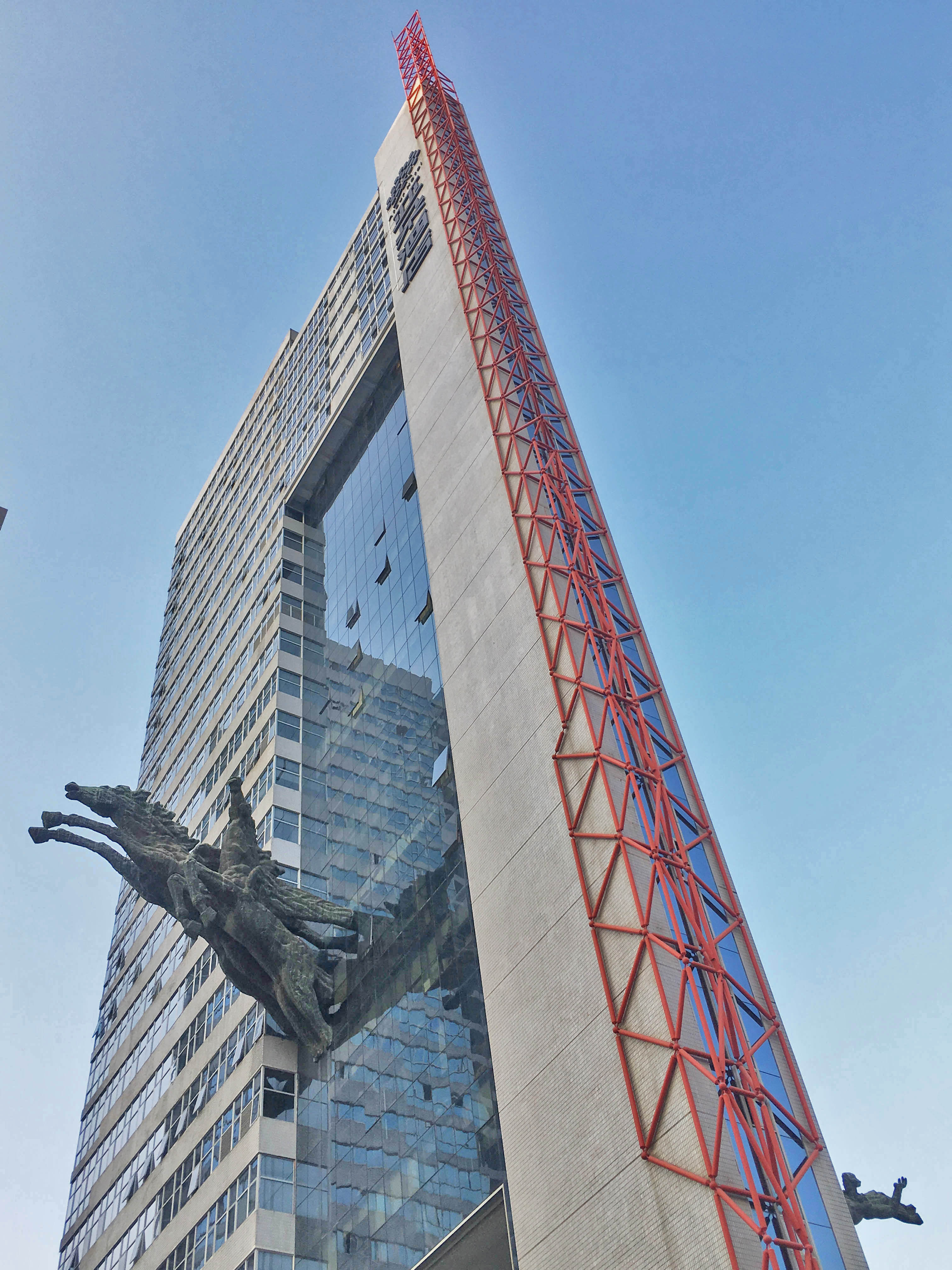 a tall building with a statue of a horse