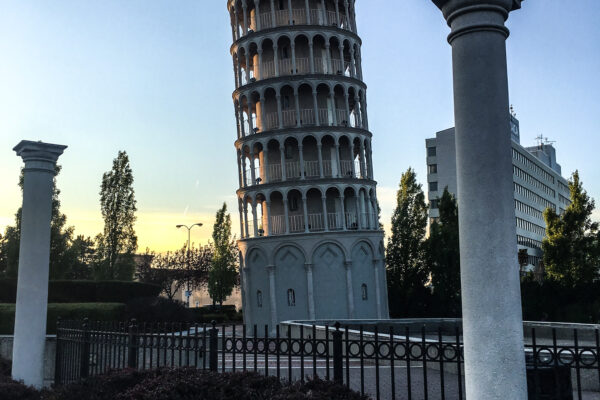 a tower with columns and a fence