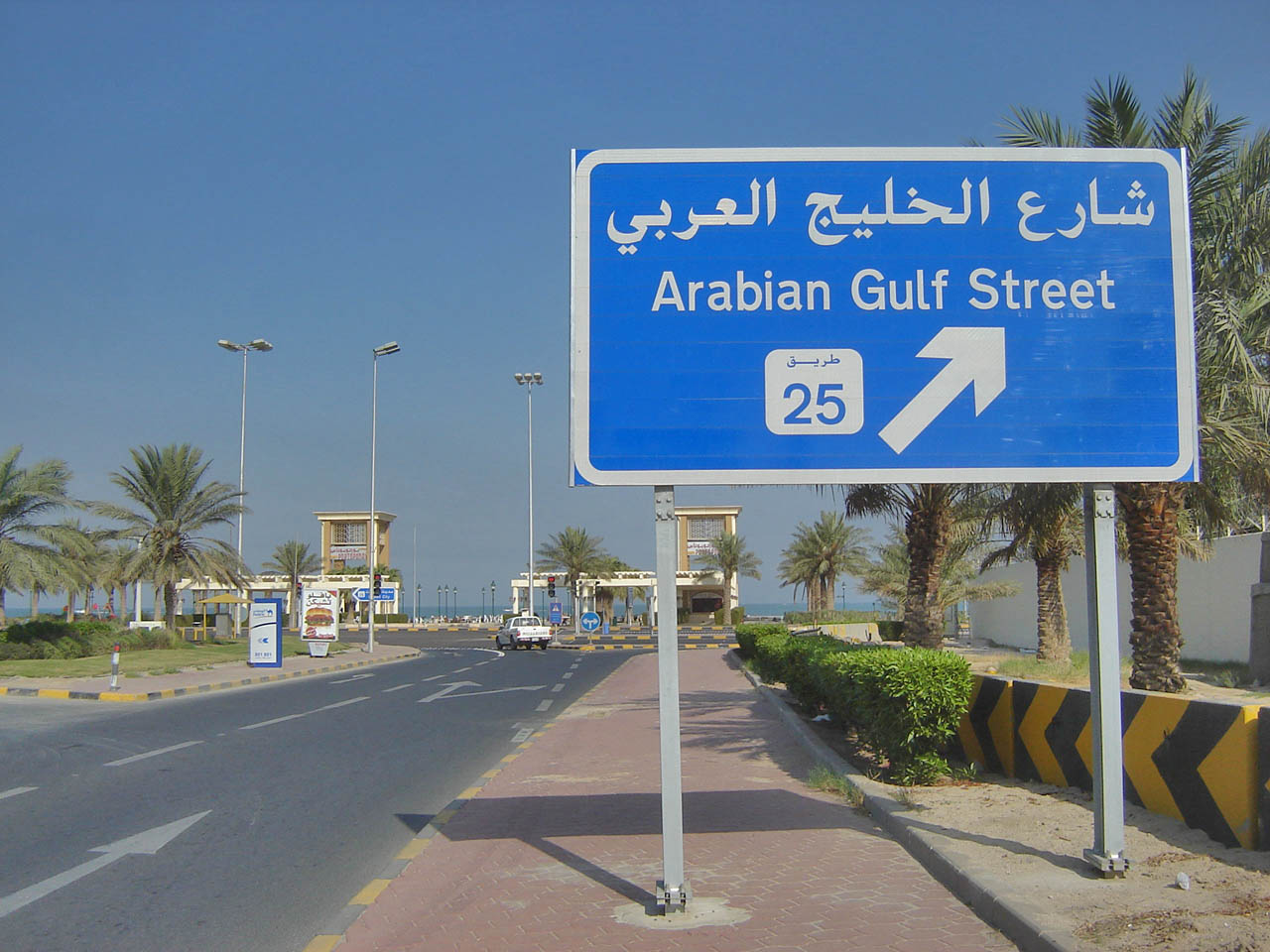 a blue sign on a road