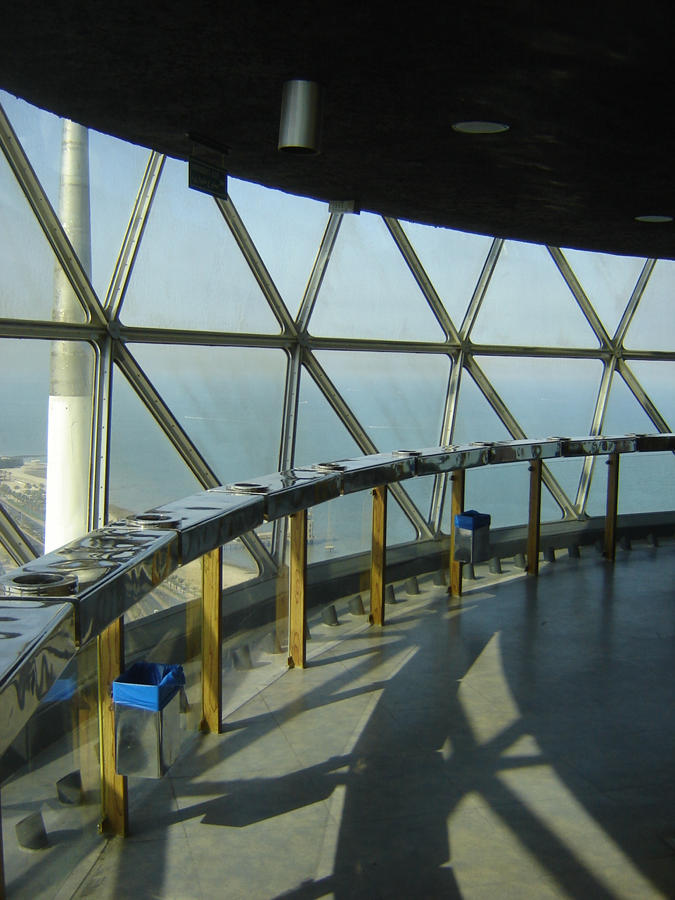 a glass wall with a row of metal containers