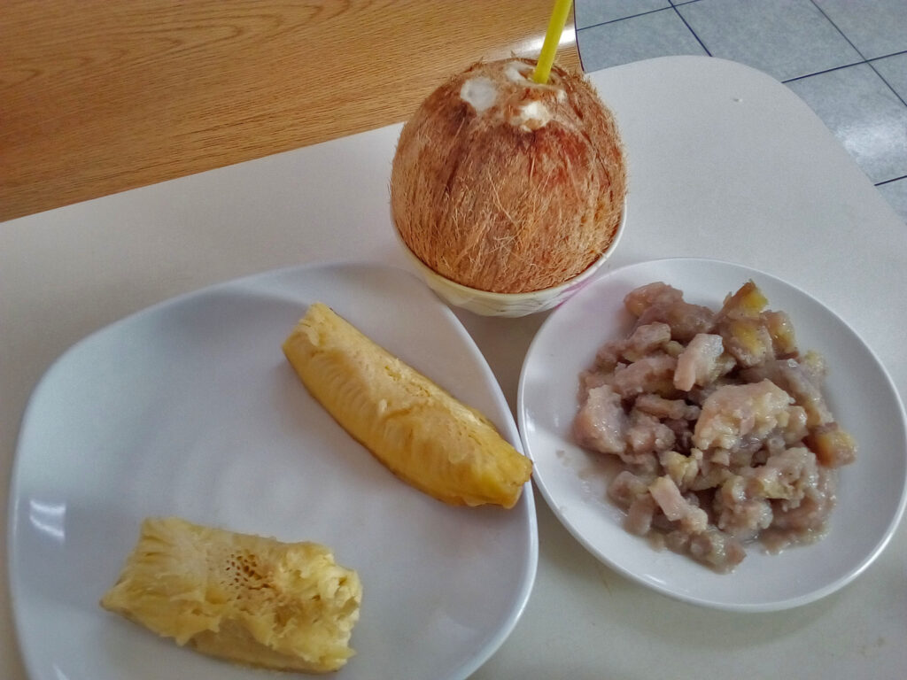 a plate of food and a coconut on a table