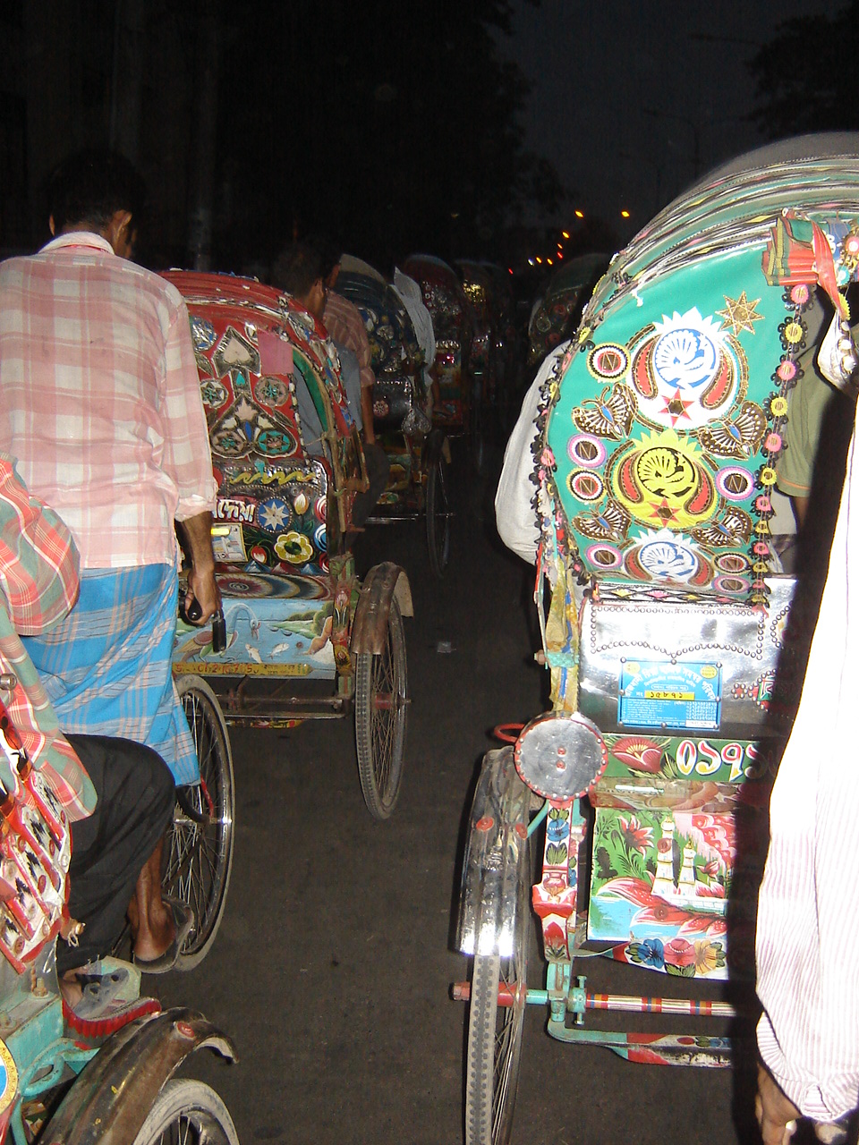 a group of people riding rickshaws