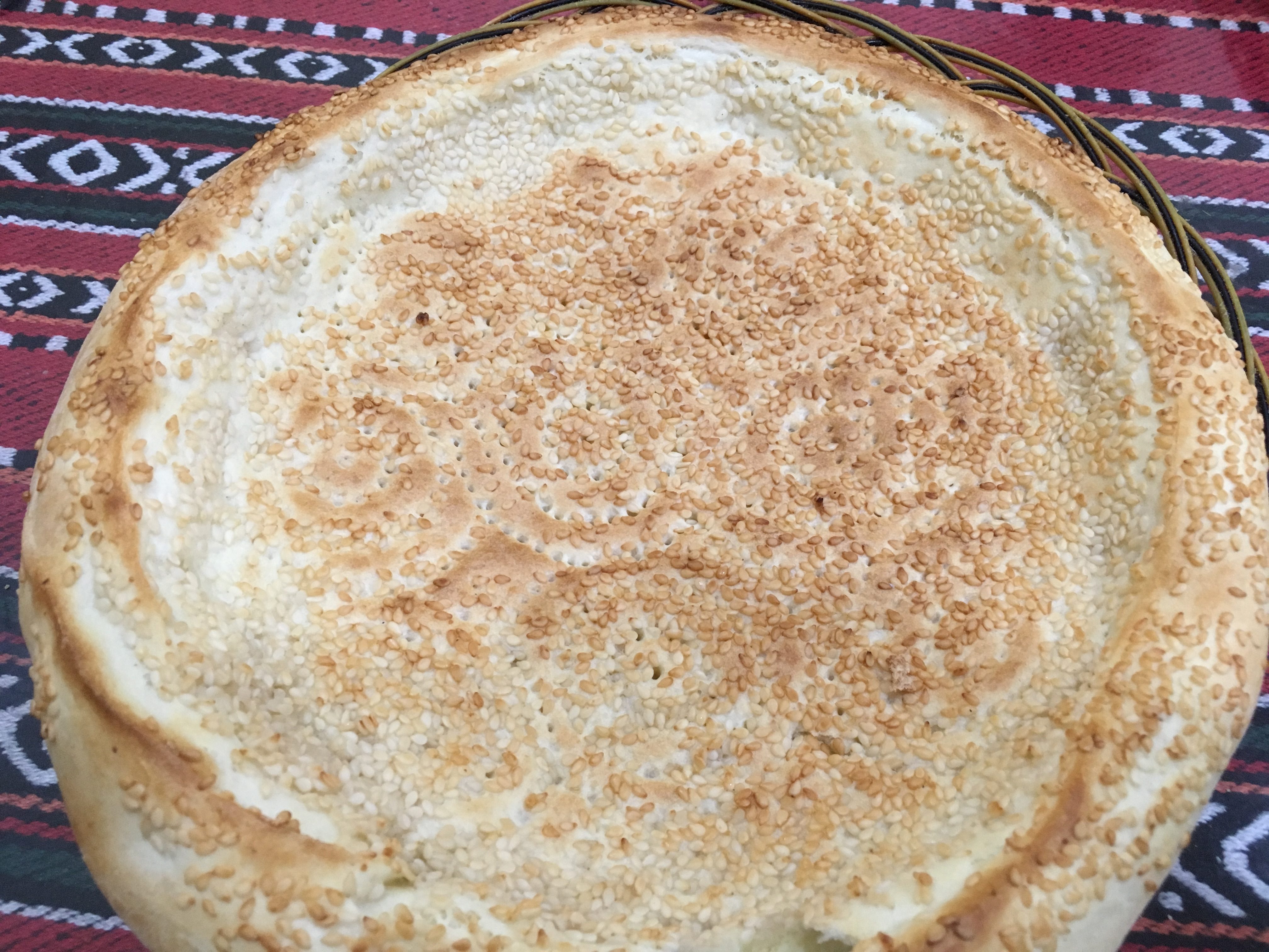a round pie with sesame seeds on top