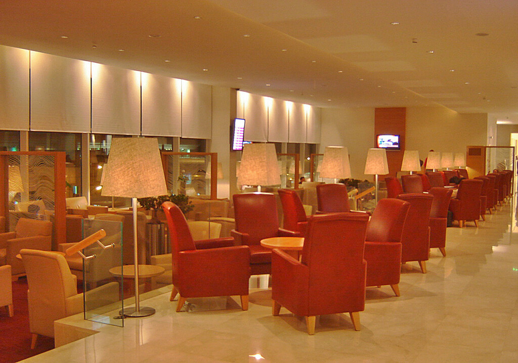 a room with red chairs and tables