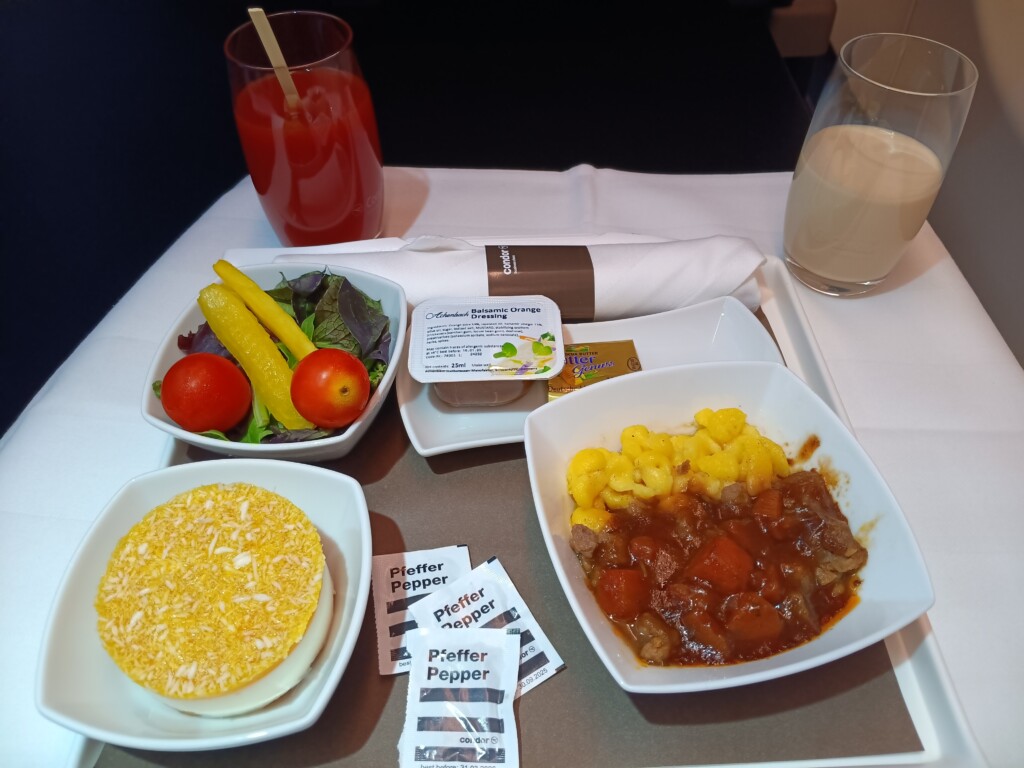 German Red Wine-Braised Beef Stew with Swabian Noodles, Salad, and Mango Coconut Tartlet