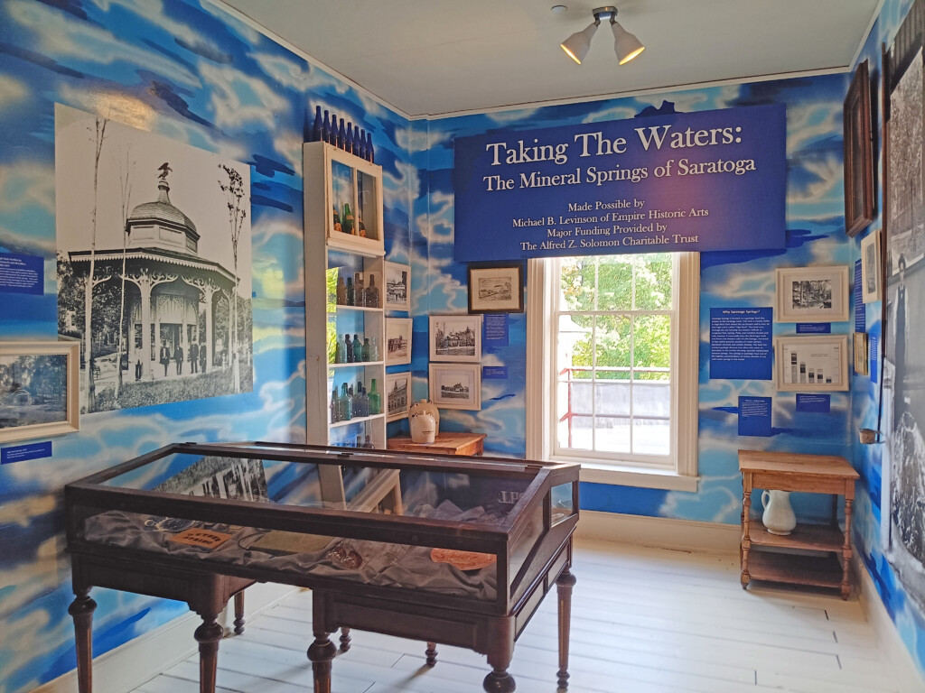 a room with a glass case and a sign