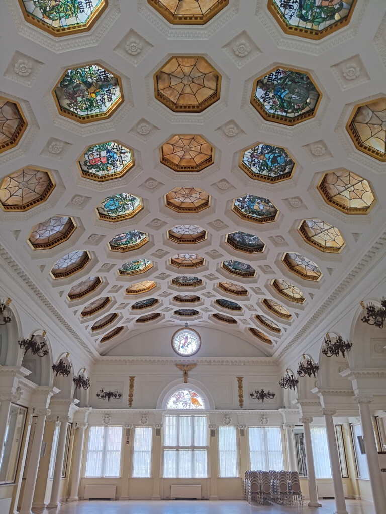 a ceiling of a building with stained glass windows