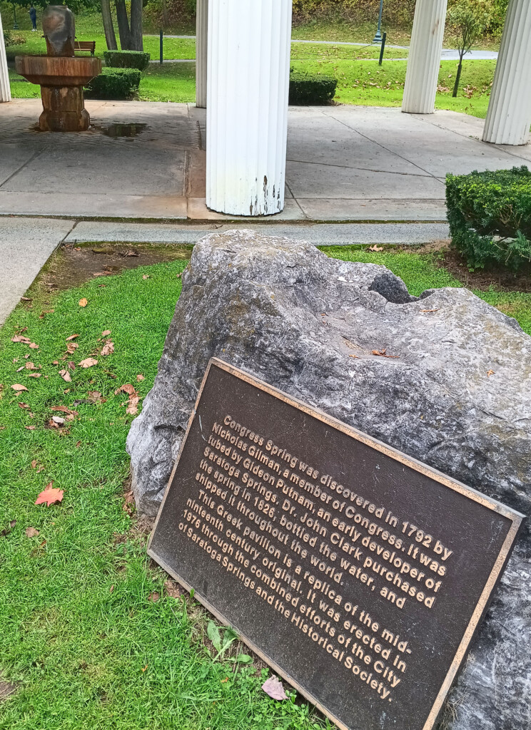 a stone sign in a park