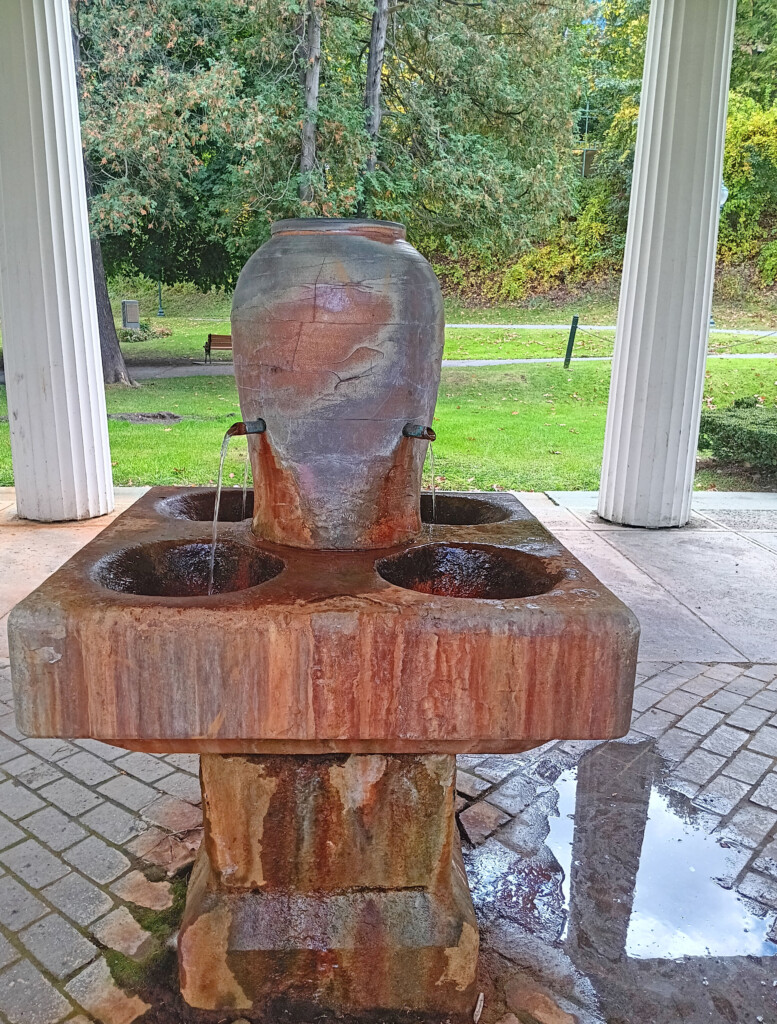 a stone fountain with water running out of it