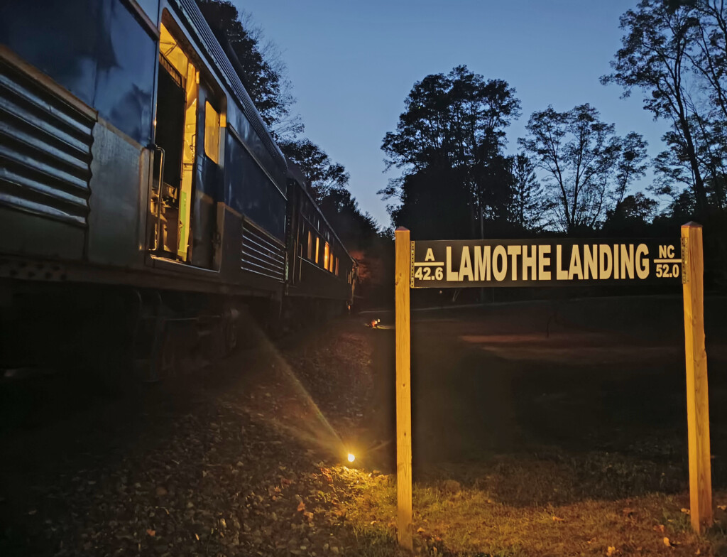 a sign next to a train