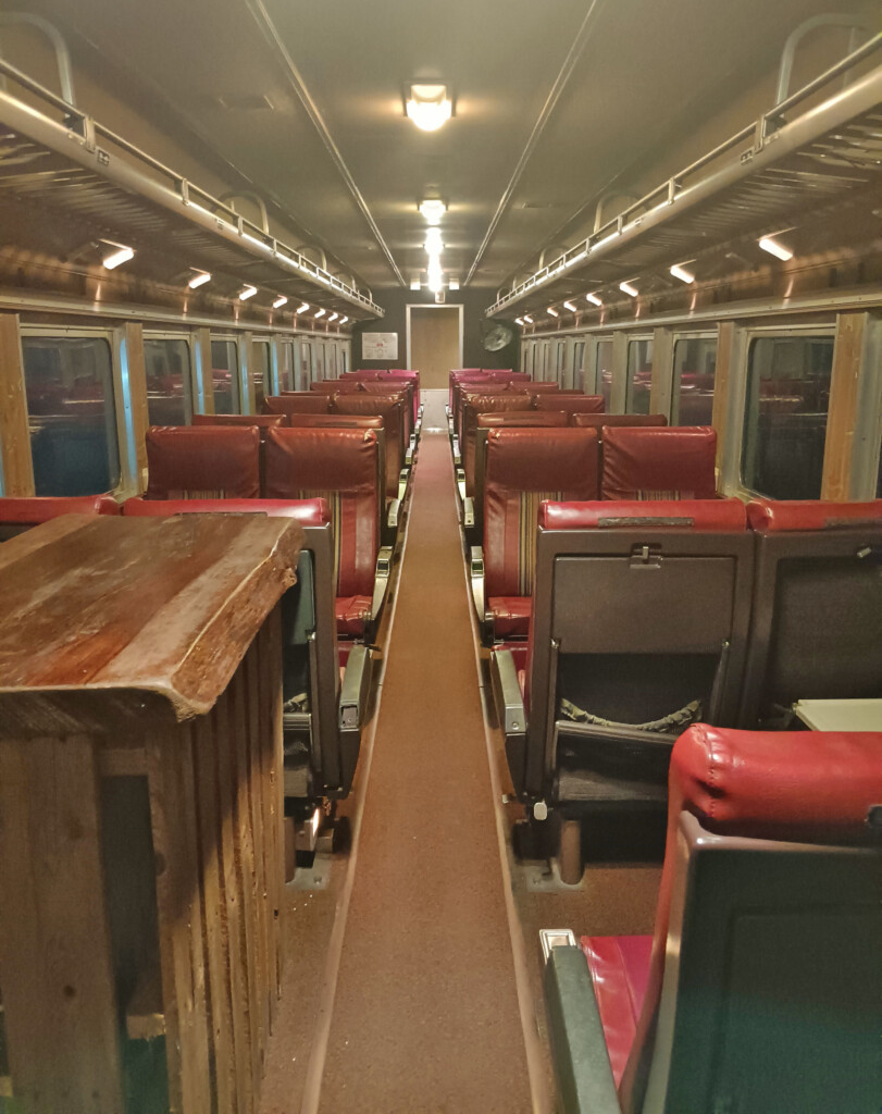 inside a train with red seats