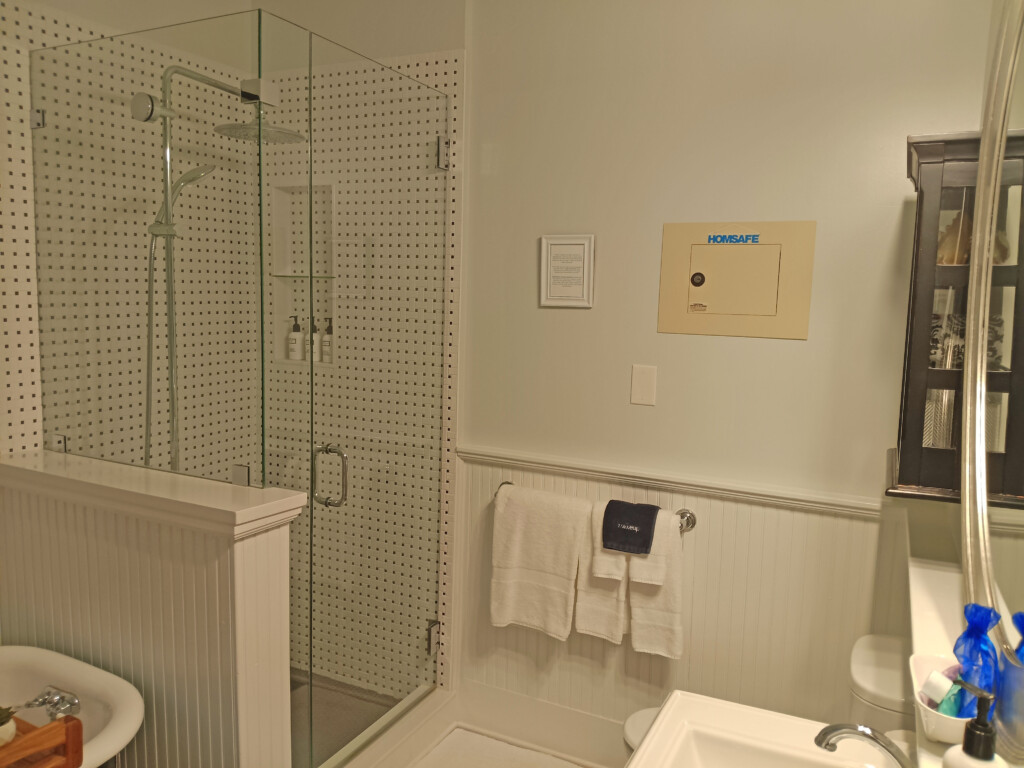 a bathroom with a glass shower and toilet