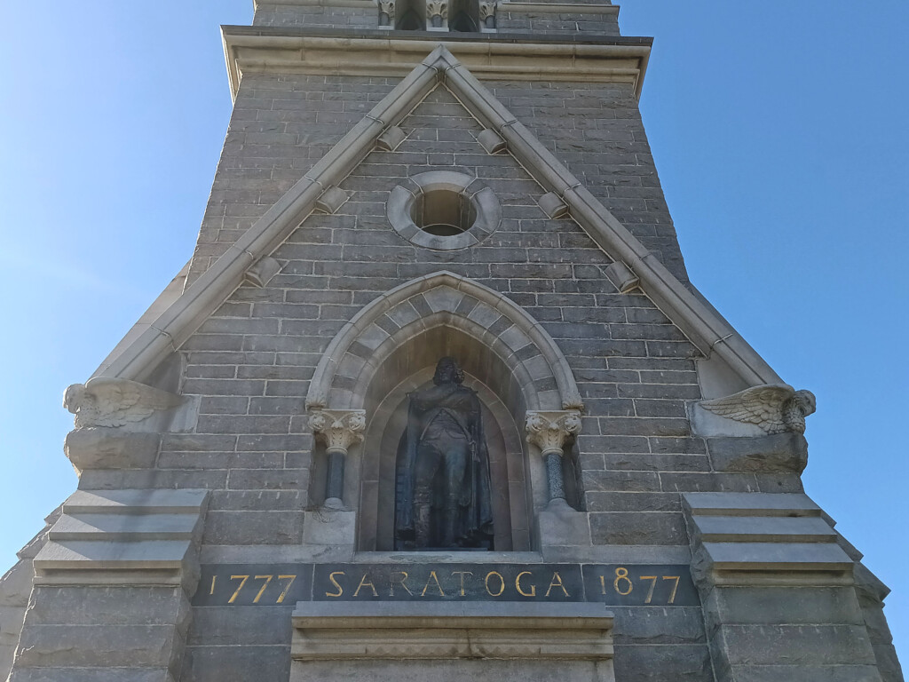 a stone building with a statue on the side