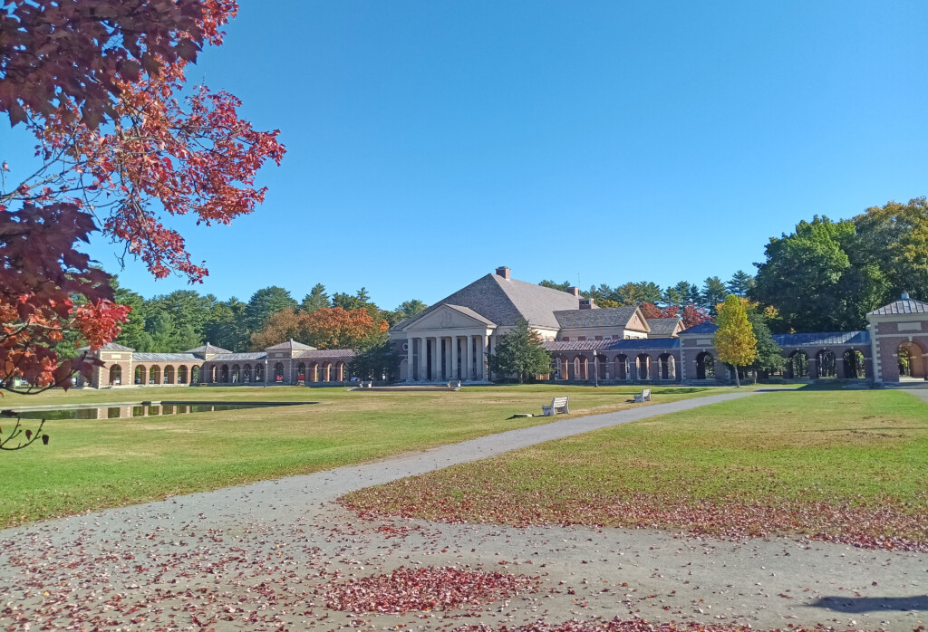 a large building with columns and a lawn