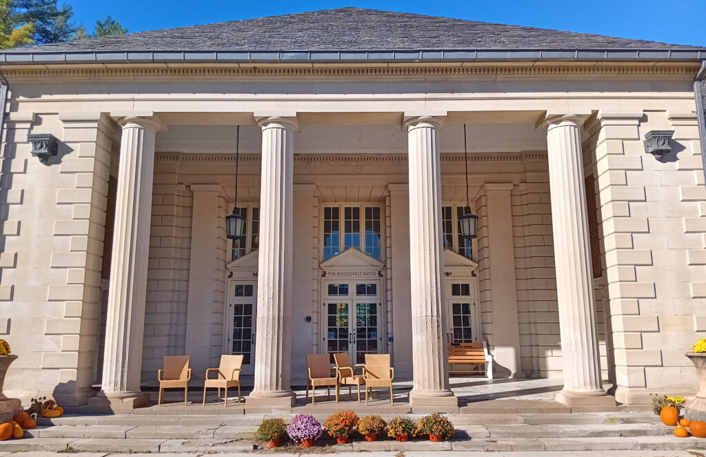 a building with columns and chairs