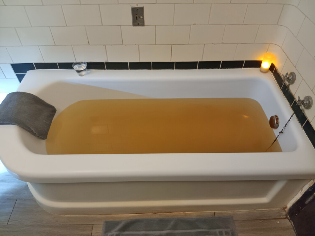 a bathtub with brown liquid in it