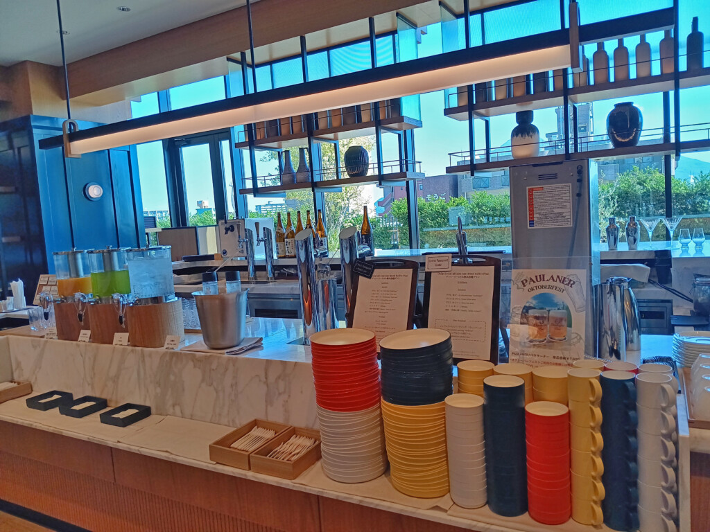 a counter with different colored cups and utensils