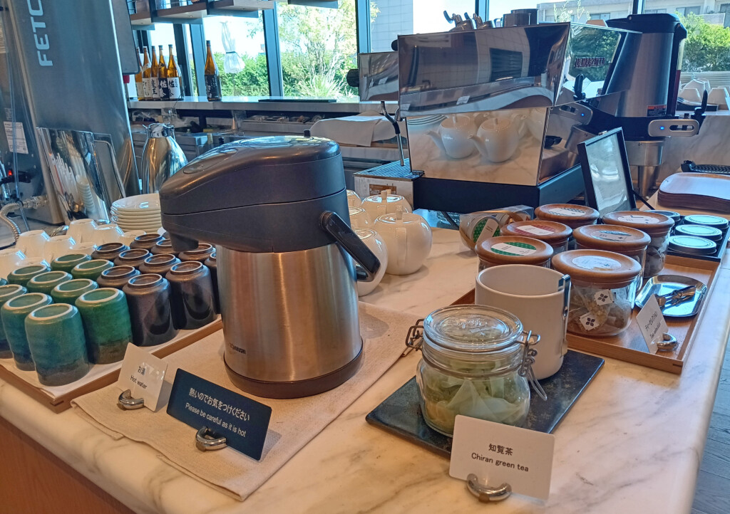 a coffee maker and jars on a counter