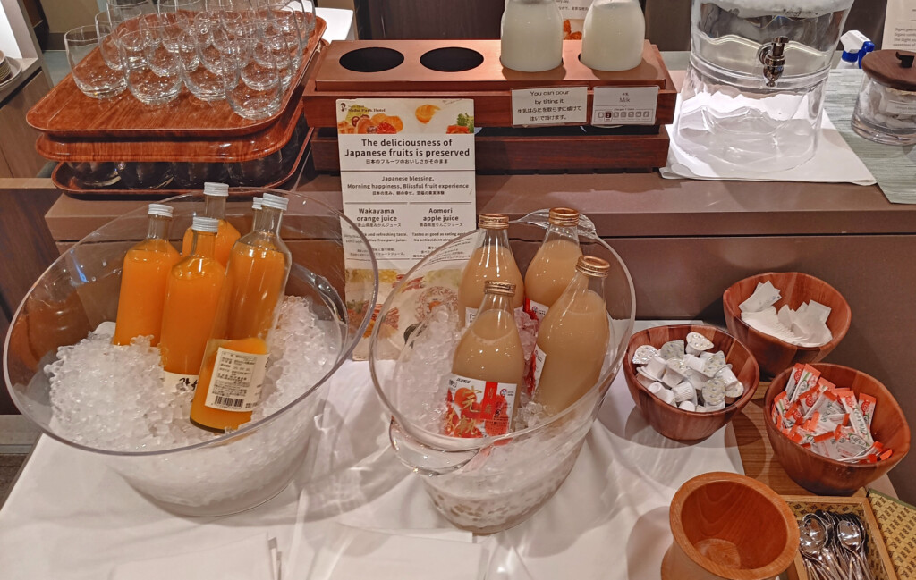 a table with bottles of juice and ice