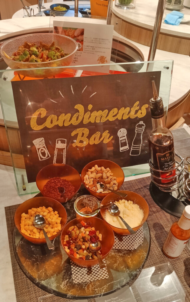 a table with bowls of food and a sign