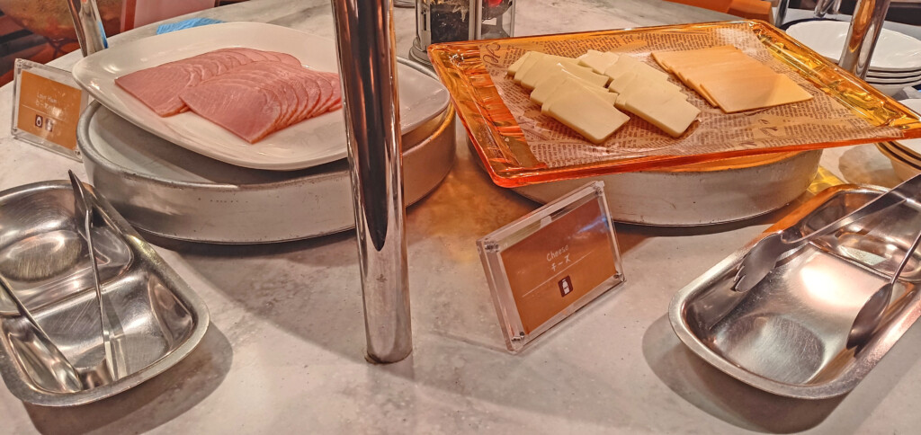 a plate of cheese and ham on a table