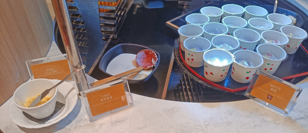 a tray of yogurt cups and a spoon