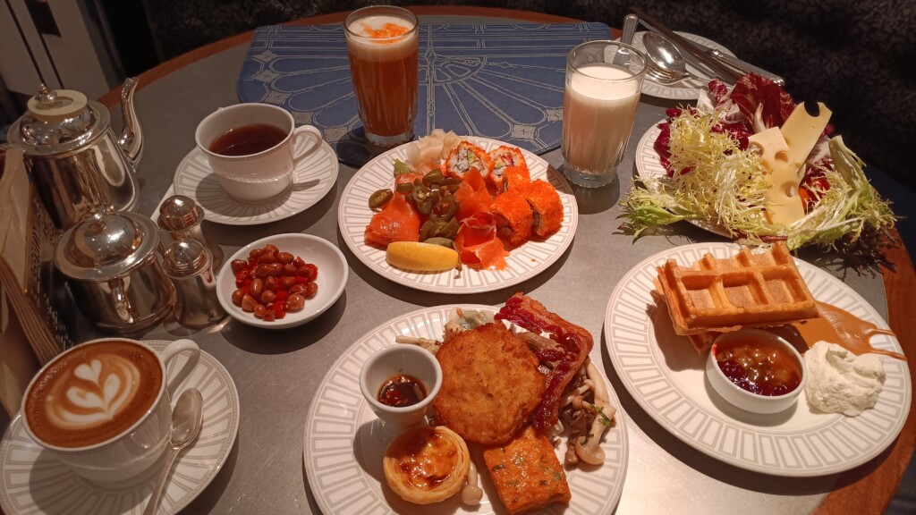 a table with plates of food and drinks