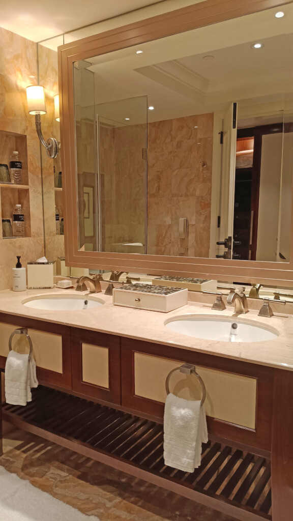 a bathroom with double sinks and a large mirror