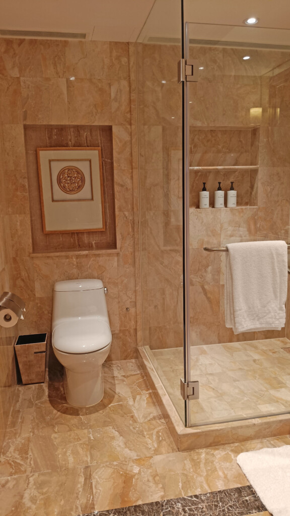 a bathroom with a glass shower door