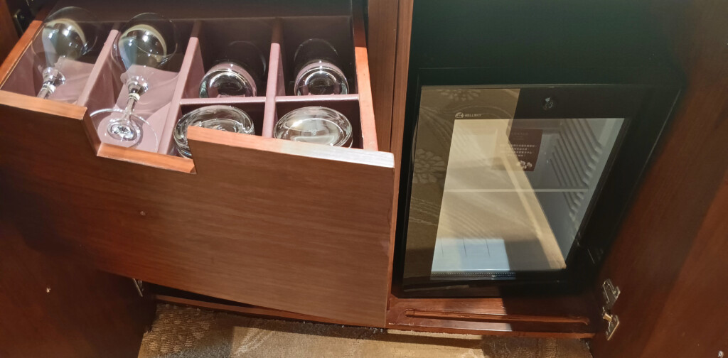 a wooden cabinet with jars in it