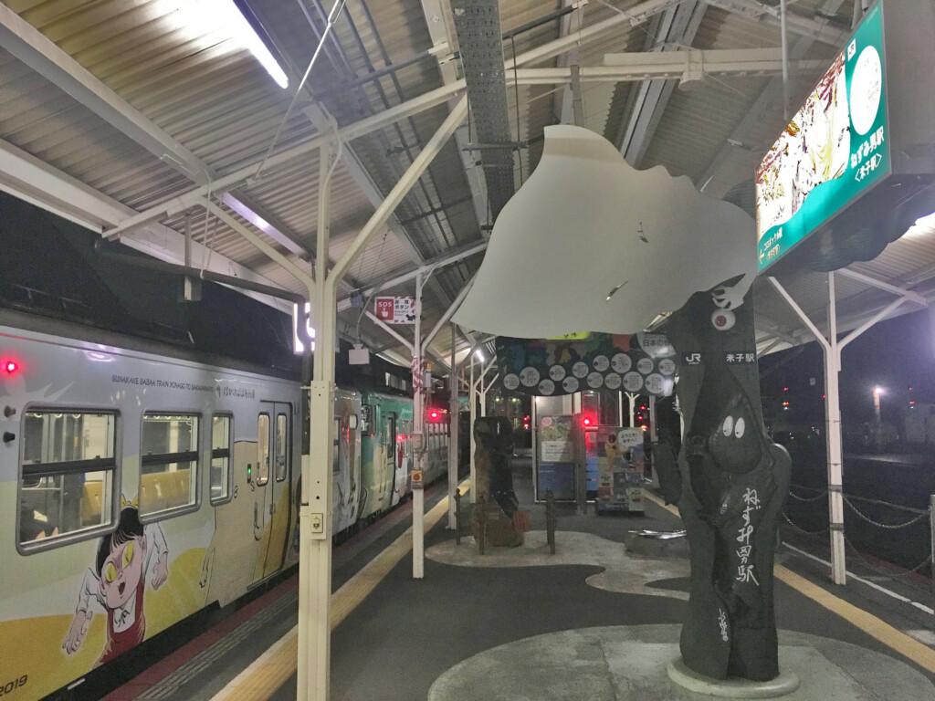 a train station with a statue