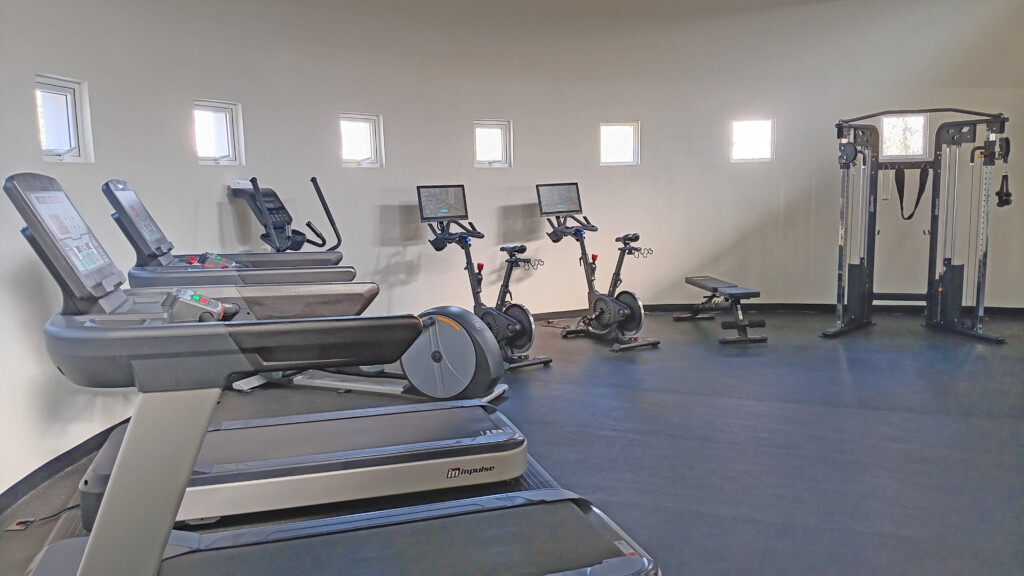 a room with exercise machines and treadmills