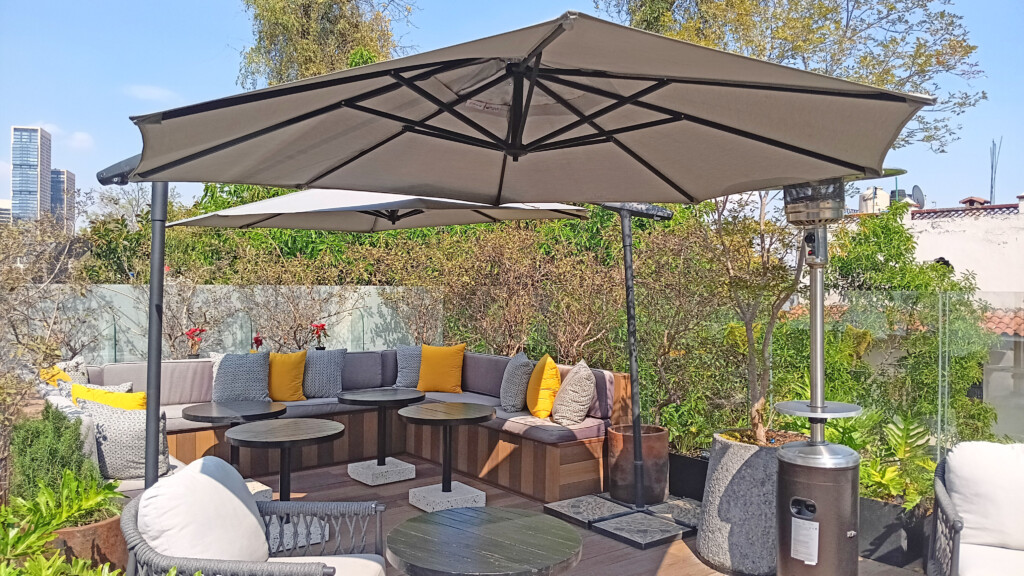 a patio with a large umbrella and a couch