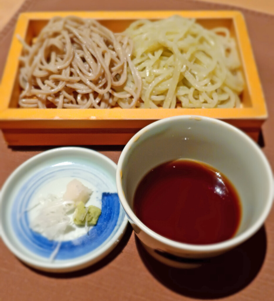 a bowl of noodles and a bowl of sauce
