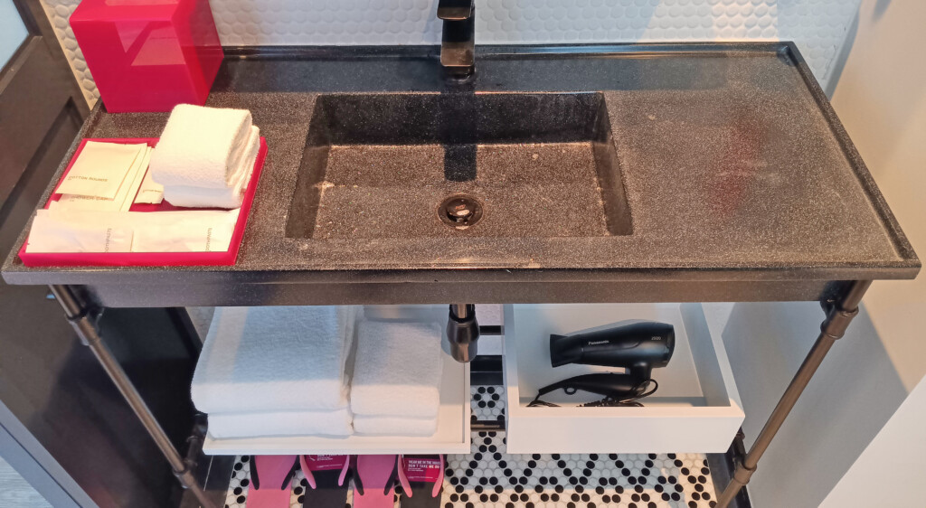 a sink with a shelf under it