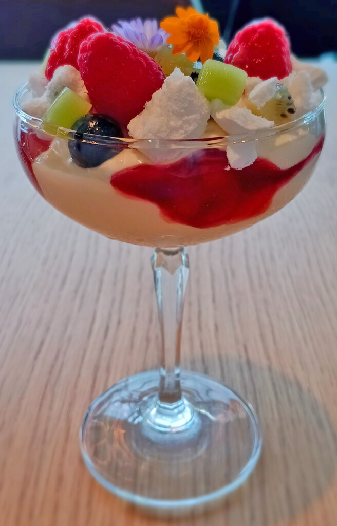 a glass of fruit dessert