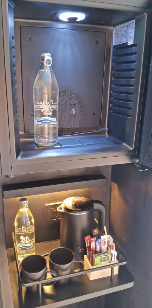a bottle of water on a shelf