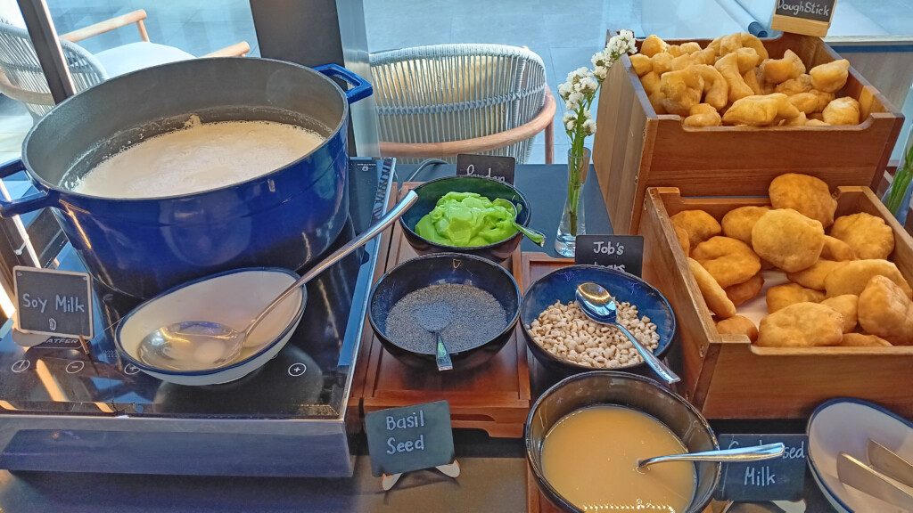 a table with bowls of food and a sign