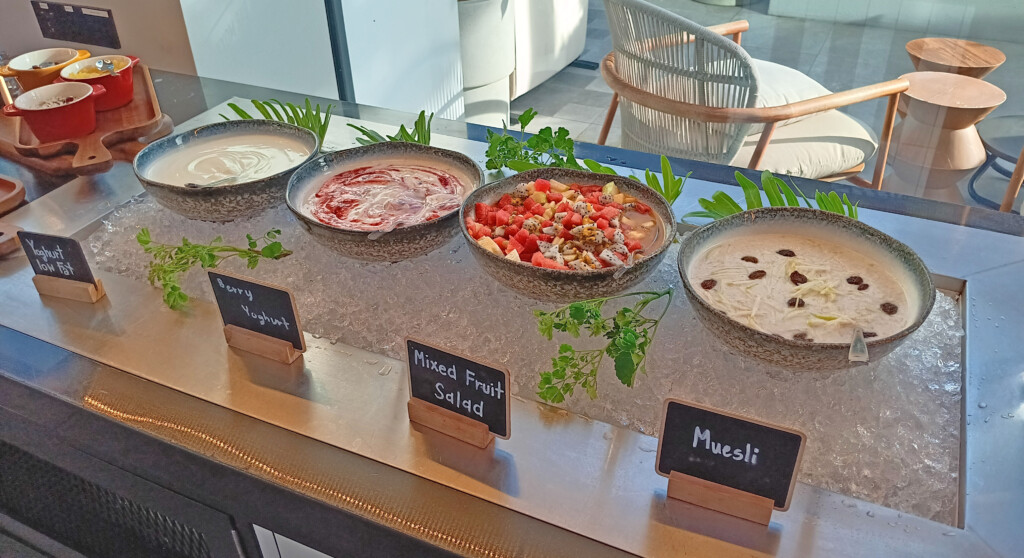 a row of bowls of food on ice