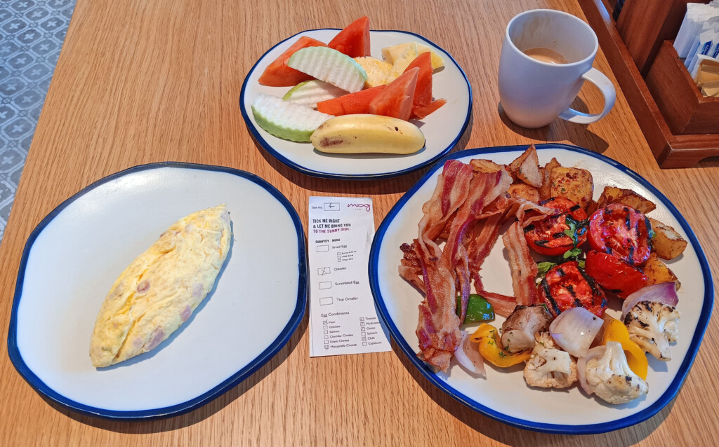 a plate of food and a coffee cup on a table