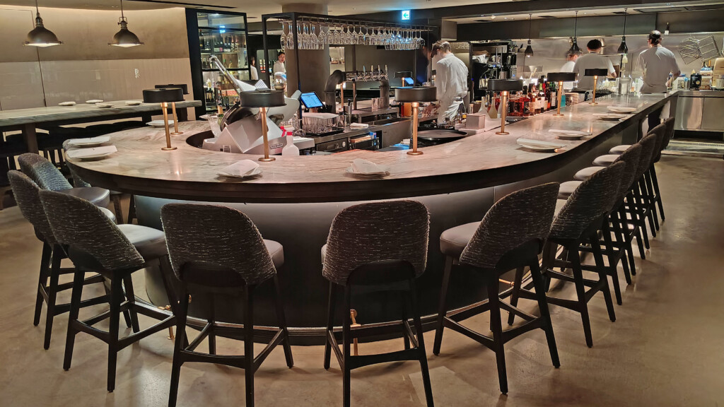 a bar with chairs and a counter