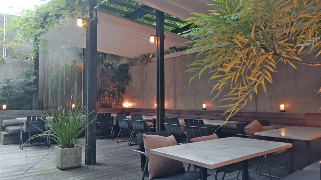 a patio with tables and chairs