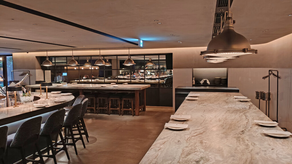 a large kitchen with a large counter and chairs