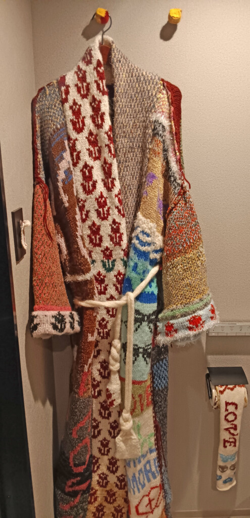 a group of knitted clothes on a swinger