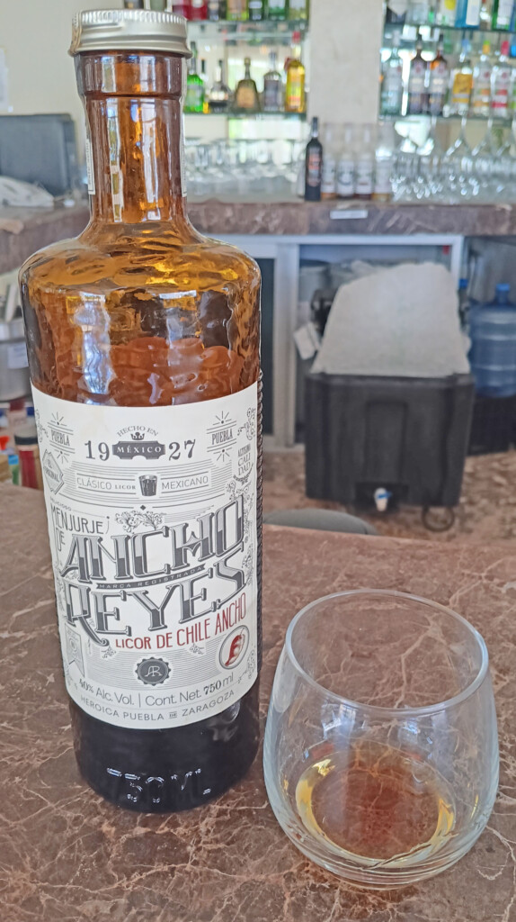 a bottle of alcohol next to a glass