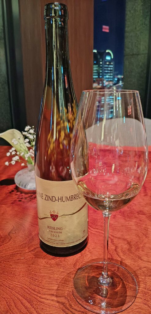 a bottle of wine next to a glass