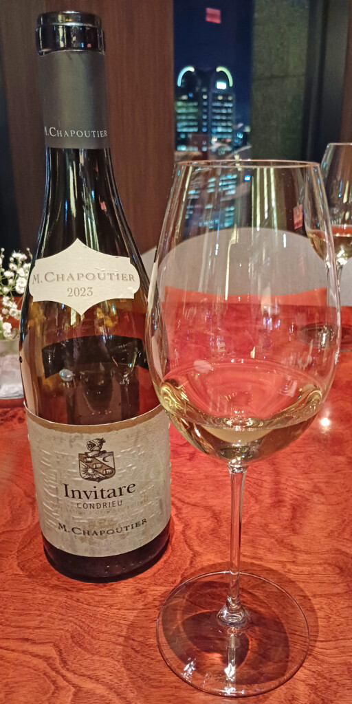 a bottle of wine next to a glass