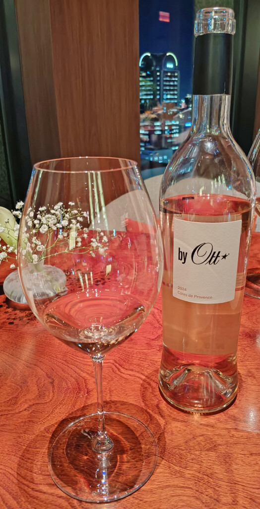 a bottle of wine next to a glass