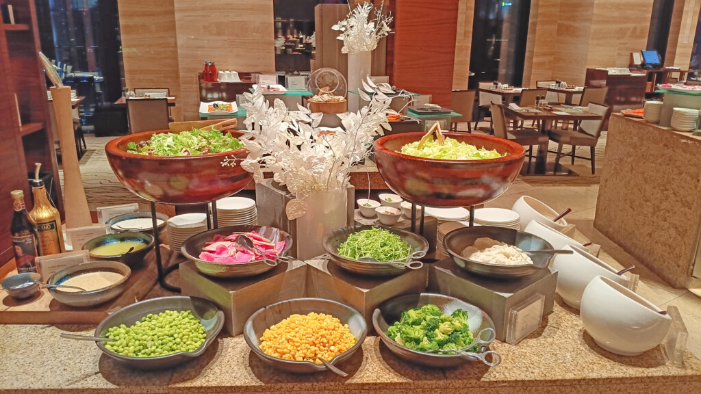 a buffet table with different bowls of food