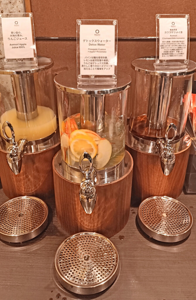 a group of juice dispensers on a table